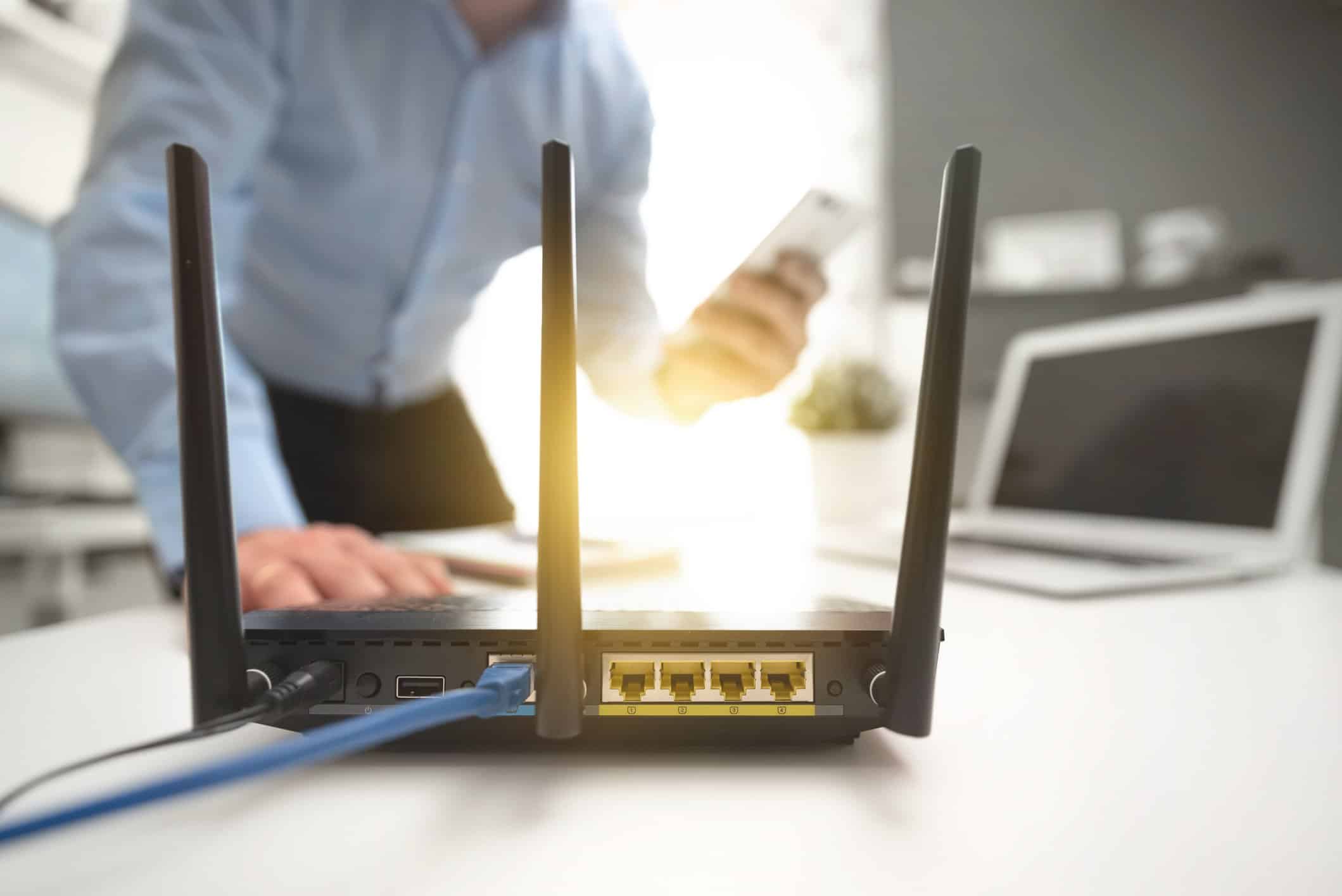 Wireless router concept man using smartphone